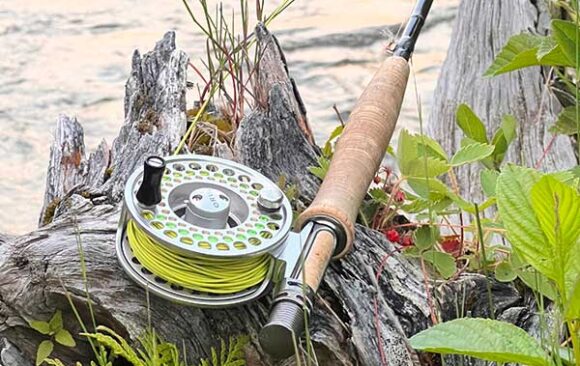 Fly rod and reel on river bank